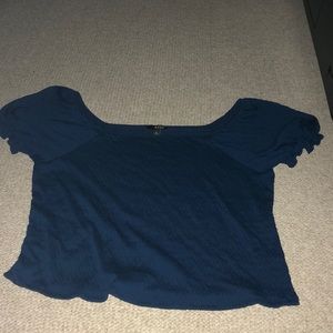 A dark blue shirt with ruffly sleeves